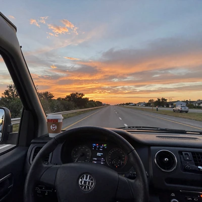 Sunset view from a truck cab on I-80 showing the open highway